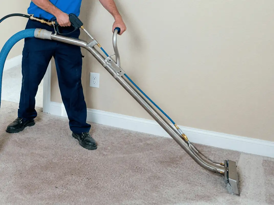 Professional operating a liquid removal machine on a carpeted floor in Atlanta, GA