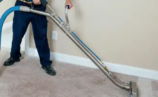 Professional operating a liquid removal machine on a carpeted floor in Atlanta, GA